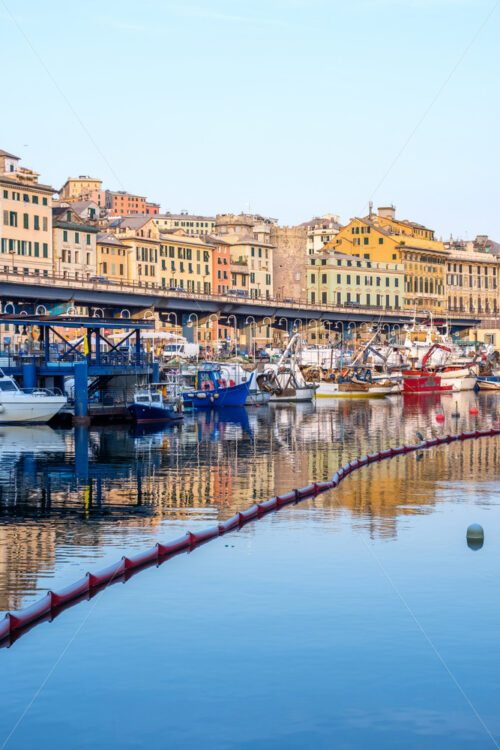 Ships parked in Porto Antico at sunset. Genoa, Italy - Starpik