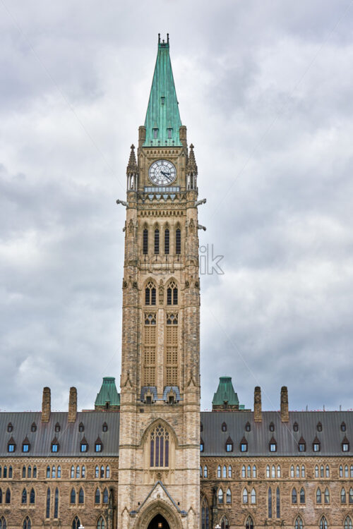 Shot of The Peace Tower also known as the Tower of Victory and Peace with gray cloudy sky in the background - Starpik