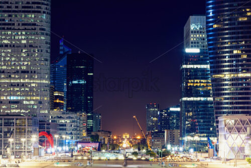 Tall city business buildings. Warm light in Paris, France - Starpik