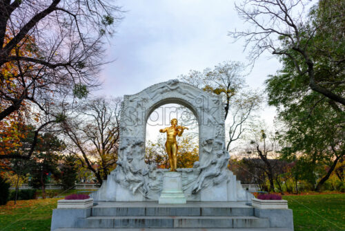 The golden-plated statue of music composer Johann Strauss. Daylight view - Starpik