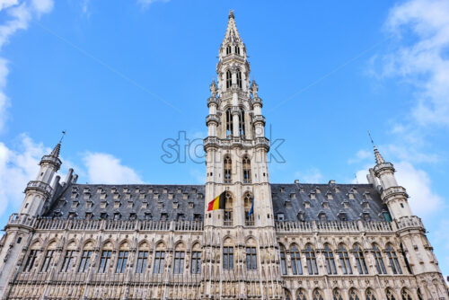 Town hall in the Grand Place from low view. Clear sky with a few clouds on background - Starpik