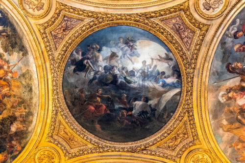 VERSAILLES, FRANCE – SEPTEMBER 29, 2018: Old art on the ceilings of the Versailles Palace. Golden decorations with wonderful images - Starpik