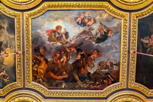 VERSAILLES, FRANCE – SEPTEMBER 29, 2018: Old art on the ceilings of the Versailles Palace. Golden decorations with wonderful images - Starpik