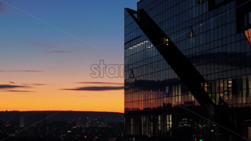 Video Aerial drone view of a glass building in Chisinau, Moldova at sunset - Starpik