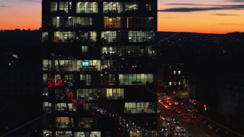 Video Aerial drone view of a glass building in Chisinau, business people working at the office, Moldova at sunset - Starpik