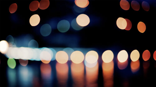 Video Blurry, circular light patterns in various warm and cool tones, set against a dark background - Starpik