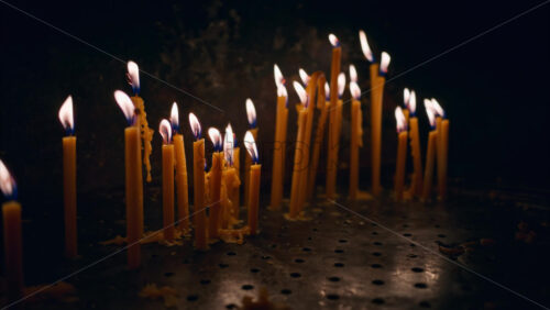 Video Close up of multiple stick candles burning in a church - Starpik Stock