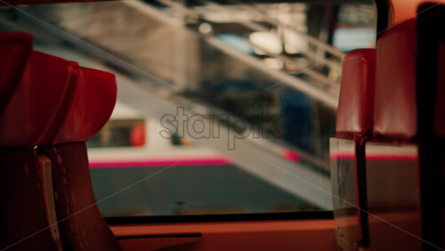 Video Close up of the seats near the window of a moving train with a blurry view - Starpik Stock