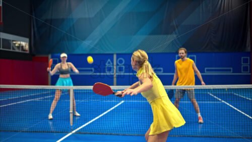 Video Two men and two women playing pickleball on a blue, inside court - Starpik