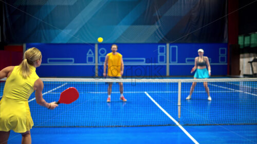 Video Two men and two women playing pickleball on a blue, inside court - Starpik