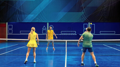 Video Two men and two women playing pickleball on a blue, inside court - Starpik