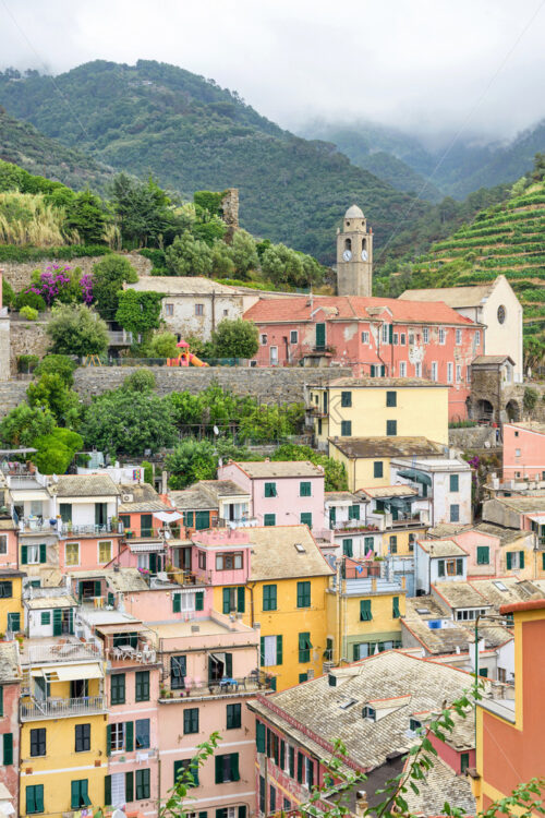 View to city, belltower and green mountains of Vernazza - Starpik