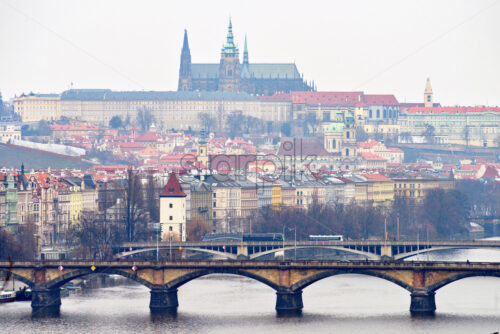 Vltava river and bridges with cars riding. Cathedral of St. Vitus and old city on background. Negative copy space, place for text. Prague, Czech Republic - Starpik