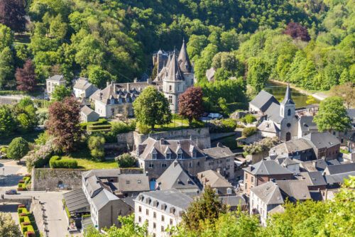 Wide view to city from above. Green trees and medieval buildings in town. Durbuy, Belgium - Starpik