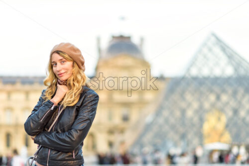 Woman at Louvre in Paris, France. Young tourist girl admiring the views. French style. Portrait soft bokeh background - Starpik