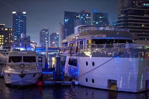 Yachts parked in Dubai Marina port at night. United Arab Emirates - Starpik