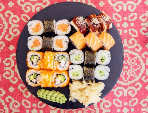 different types of sushi on a black plate - Starpik