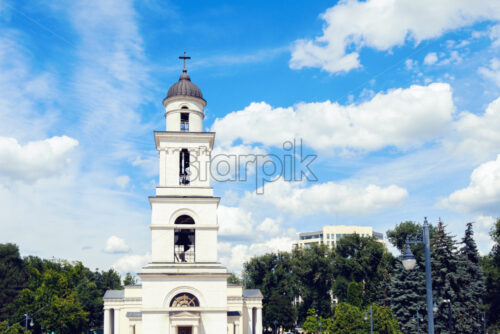 the bell tower in downtown Chisinau against the background of the blue sky, Moldova - Starpik