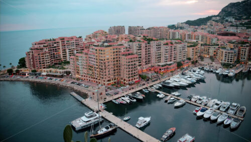 video Aerial view of boats docked in the Port de Fontvieille with the skyline of Monaco on the background in the evening - Starpik Stock