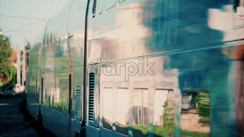 video Close up of a blue train moving on the rails near a station in France - Starpik Stock