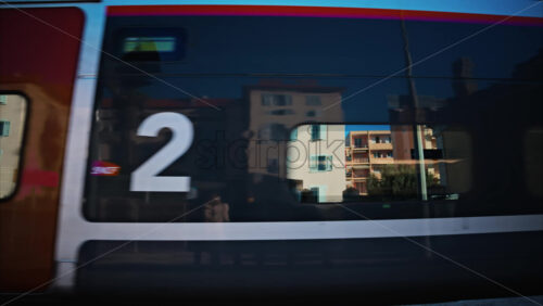 video Close up of a colourful train moving on the rails near a station in France - Starpik Stock