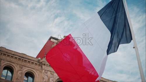 video French flag waving in front of the Mairie de Cannes Town hall in Cannes, France - Starpik Stock