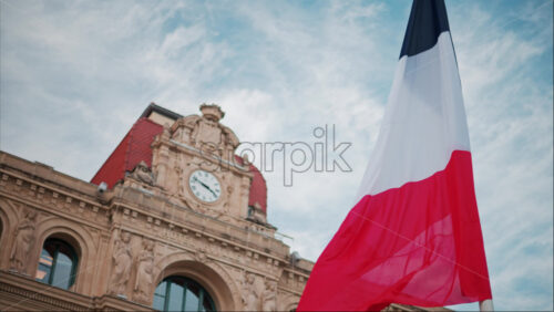 video French flag waving in front of the Mairie de Cannes Town hall in Cannes, France - Starpik Stock