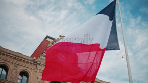 video French flag waving in front of the Mairie de Cannes Town hall in Cannes, France - Starpik Stock