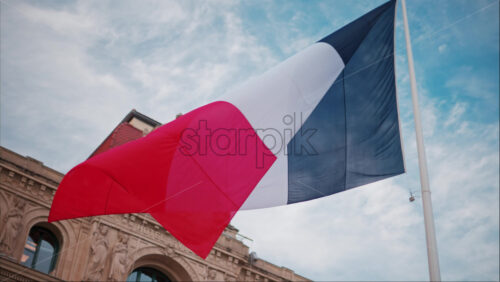 video French flag waving in front of the Mairie de Cannes Town hall in Cannes, France - Starpik Stock