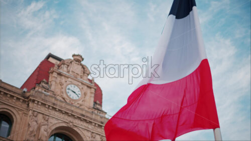 video French flag waving in front of the Mairie de Cannes Town hall in Cannes, France - Starpik Stock