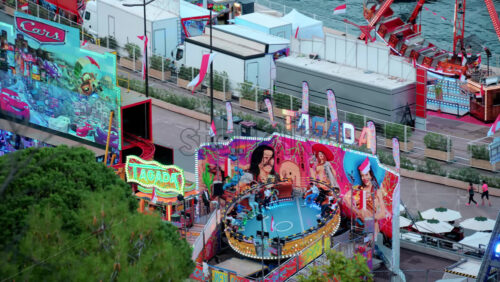 video La Condamine, Monaco – October 14, 2024: People on a ride at the Port Hercule Funfair in Monaco in daylight - Starpik Stock