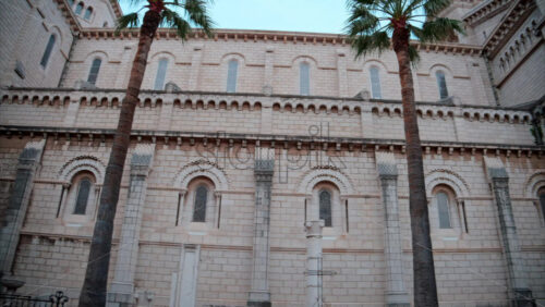 video Monaco City, Monaco – September 4, 2024: The facade of the Monaco Cathedral in the Old Town in the evening - Starpik Stock