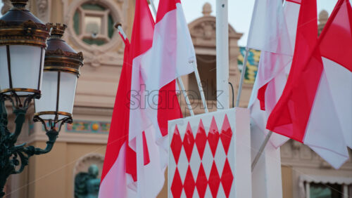 video Monte Carlo, Monaco – October 24, 2024: The coat of arms of Monaco and multiple flags waving in front of the Monte Carlo Casino - Starpik Stock