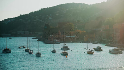 video Small boats docked on the sea in Ligurian Sea in Villefranche-sur-Mer, France seen from a moving train at sunset - Starpik Stock