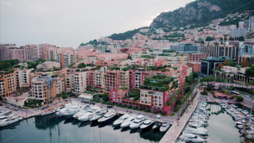 video View of boats docked in the Monaco Marina with the skyline of the city on the background - Starpik Stock