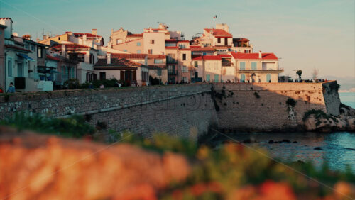 video View of different buildings on the coast in Antibes, France at sunset - Starpik Stock