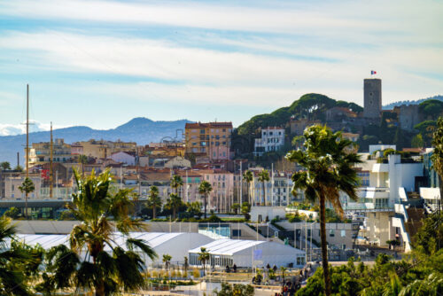 Cannes beach and castle, buildings and palm trees, France - Starpik Stock